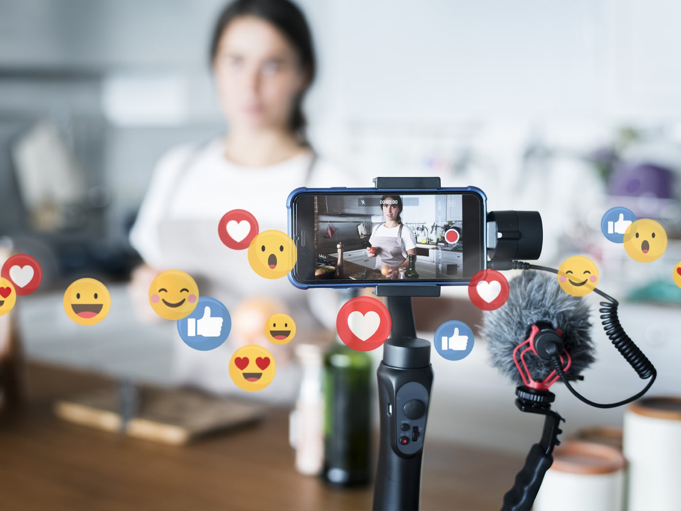 Woman recording herself on video with like and love icons floating around